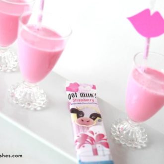 Glasses of strawberry milk with milk straws, a great Valentine's Day treat.