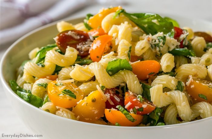 A delicious bowl of tomato and spinach pasta salad.