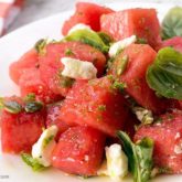 A plate with a refreshing watermelon basil salad.