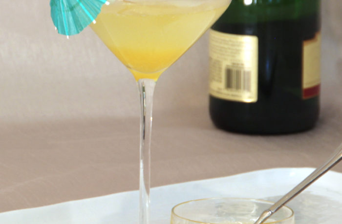 A glass with a refreshing apricot bellini champagne cocktail.