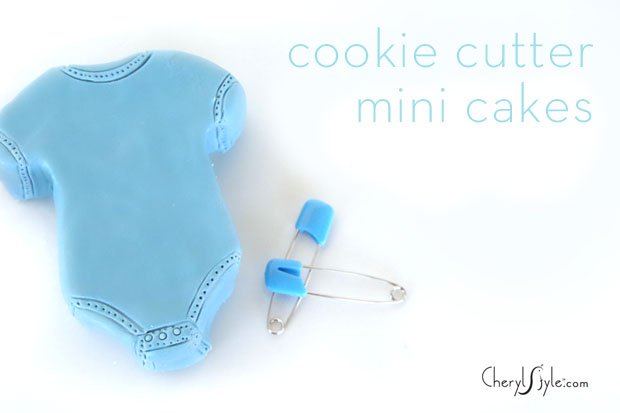 A blue mini onesie baby shower cake.