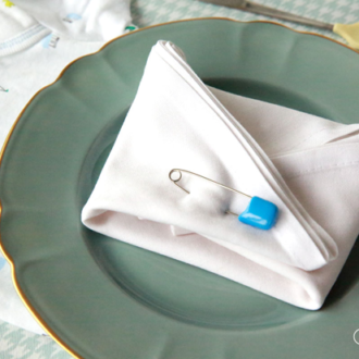 A DIY onesie baby shower place setting.