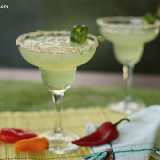 Two glasses of a spicy margarita with jalapenos