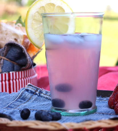 A glass of refreshing homemade blueberry lemonade.