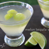 A glass of a frozen melon tequila spritzer.