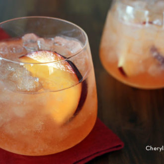 Two glasses of a refreshing apple plum cocktail.