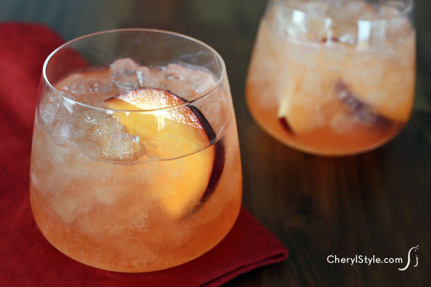 Two glasses of a refreshing apple plum cocktail.