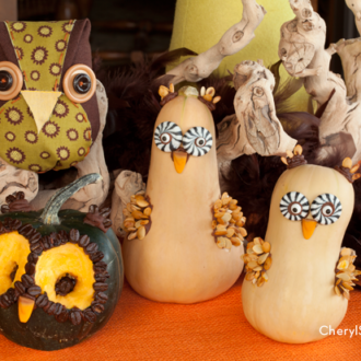 Four gourds decorated for Halloween.