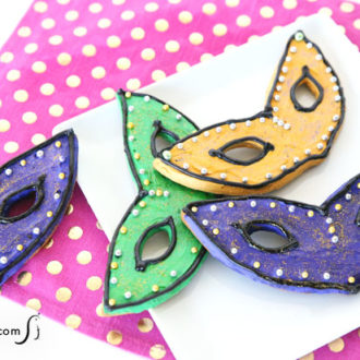 Some cute decorated Mardi Gras mask cookies.