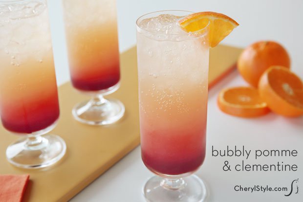 Three glasses of sparkling pomegranate and clementine cocktail.