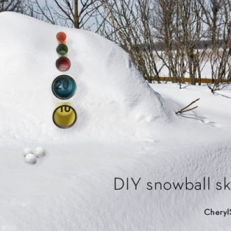 A DIY skee ball game set up to be played in the snow with snowballs.