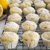 A fresh batch of lemon zucchini muffins on a cooling rack.