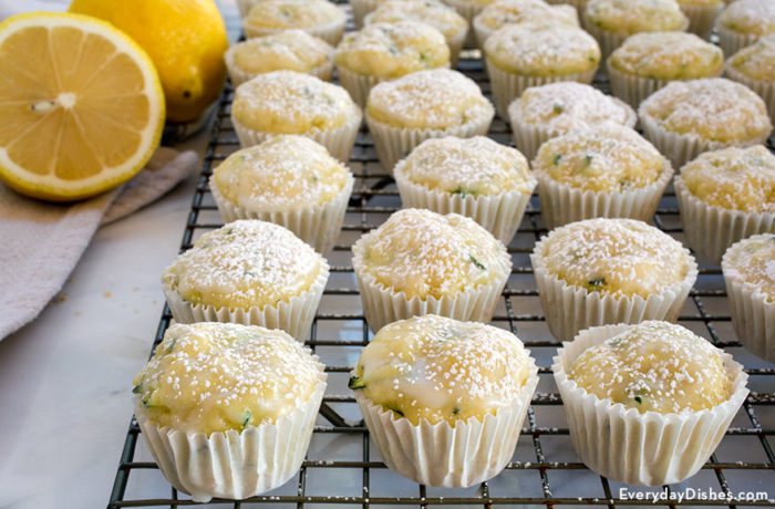 A fresh batch of lemon zucchini muffins on a cooling rack.