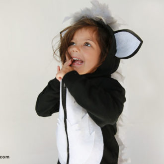 A child wearing a DIY skunk hoodie costume
