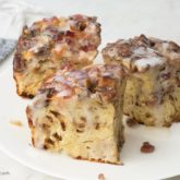 Three delicious slices of challah French toast casserole on a plate.