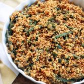 A pan full of a fresh green bean casserole, ready to serve as a side dish.
