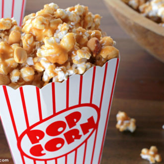 Homemade peanut caramel corn in a personal popcorn cup.