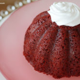 A mini red velvet cake with whipped cream, ready to enjoy