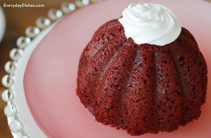 A mini red velvet cake with whipped cream, ready to enjoy