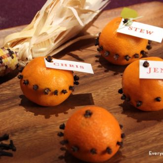 Thanksgiving place cards made out of oranges and cloves.