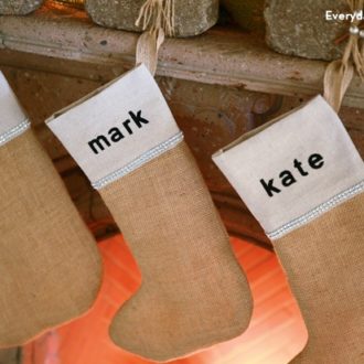 Some DIY stenciled burlap Christmas stockings to give your mantel a rustic look.