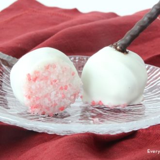 Two delicious Christmas cake pops on a plate.