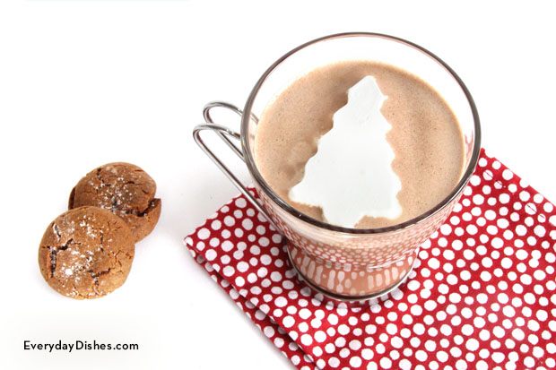 A mug of hot chocolate with cool whip marshmallows and two cookies