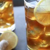 Two glasses of refreshing honey ginger iced tea with lemon.