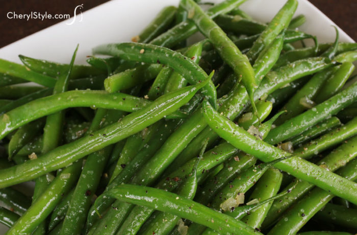 Quick sautéed green beans with shallots that are ready to serve as a side dish for dinner.