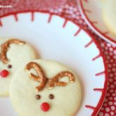 Reindeer sugar cookies with pretzel antlers, a cute holiday party treat.