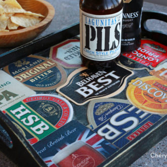 A DIY tray made from beer coasters, with two beers on it.