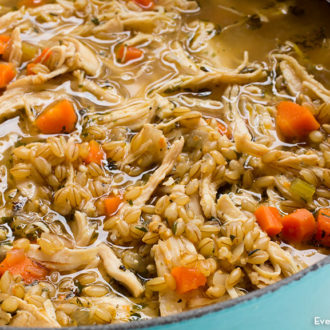 A bowl of a hearty chicken and barley soup.