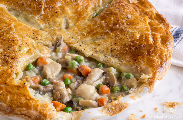 A homemade chicken pot pie with a slice taken out. A tasty dinner recipe.