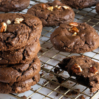 A fresh batch of chewy gluten-free chocolate cookies with pecans.