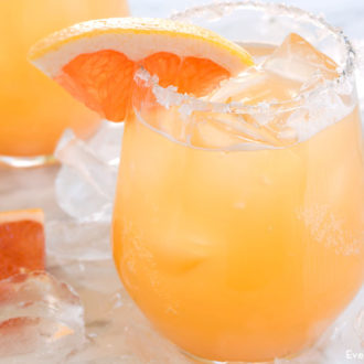 A refreshing glass filled with a greyhound grapefruit beer cocktail