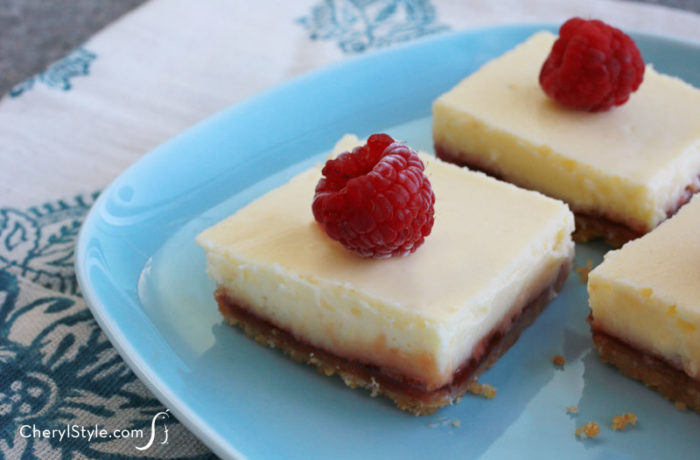 Easy-to-make raspberry lemon cheesecake bars with vanilla wafer crust, sliced into pieces and ready to enjoy for dessert.