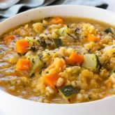 A bowl of healthy red lentil and vegetable soup, a hearty meal.
