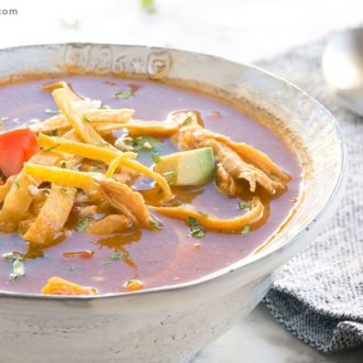 A bowl full of chicken tortilla soup that's ready to enjoy