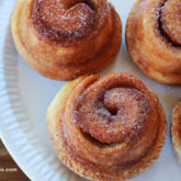 A plate of delicious morning buns on a plate — gooey cinnamon buns meets flaky croissants.