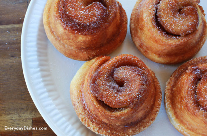 A plate of delicious morning buns on a plate — gooey cinnamon buns meets flaky croissants.