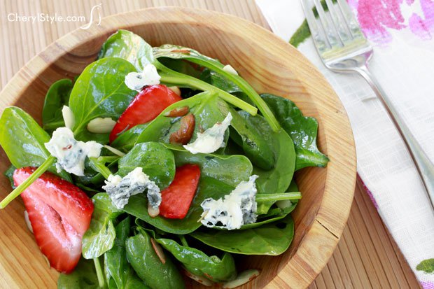 Strawberry spinach salad with lemon ginger vinaigrette, ready to enjoy for lunch.