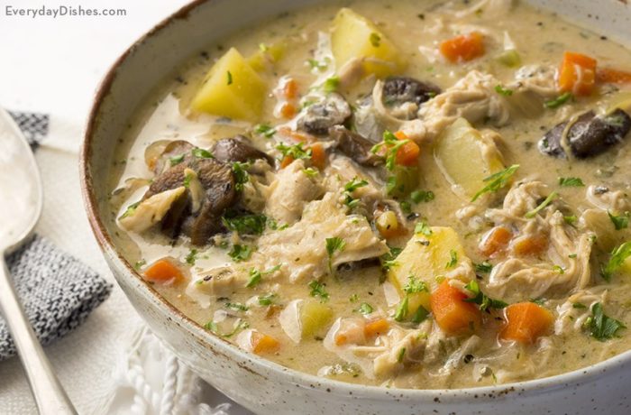 A bowl of homemade chicken soup with potatoes, carrots, and mushrooms — a great dinner on a cold night.