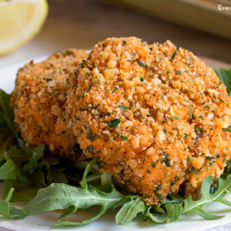 Two delicious baked salmon cakes on a plate.
