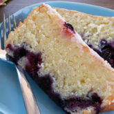Two slices of lemon blueberry bread on a plate, ready to enjoy.