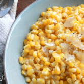 A bowl of some fast, easy, and yummy parmesan garlic corn, ready to enjoy as a side for dinner.