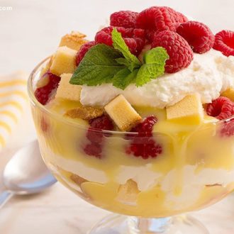 A bowl with a tasty, homemade raspberry lemon curd trifle dessert.