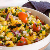 A bowl of grilled corn salsa, ready to serve as an appetizer.