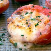 Grilled tomatoes with cheese, hot and ready to serve.