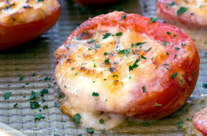 Grilled tomatoes with cheese, hot and ready to serve.