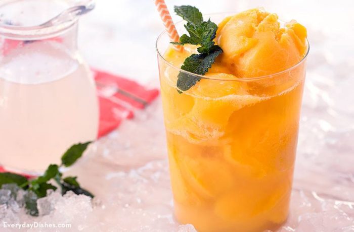 A glass full of a delightful mango mint cocktail recipe